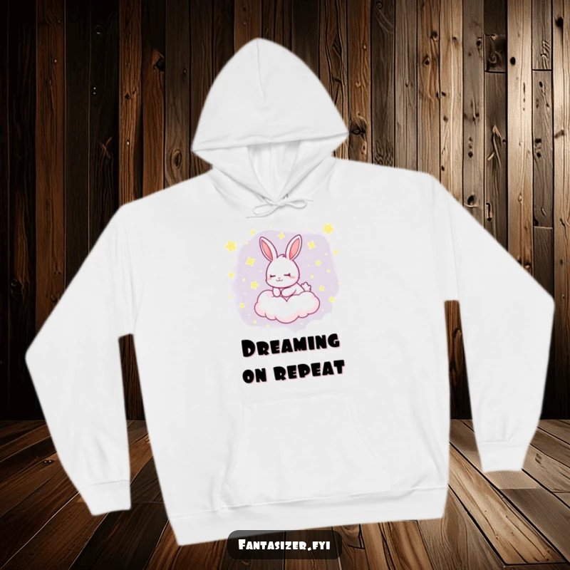 Funny hoodie with a dreaming rabbit floating peacefully on a cloud dotted with stars, offering cozy comfort and whimsical charm.
