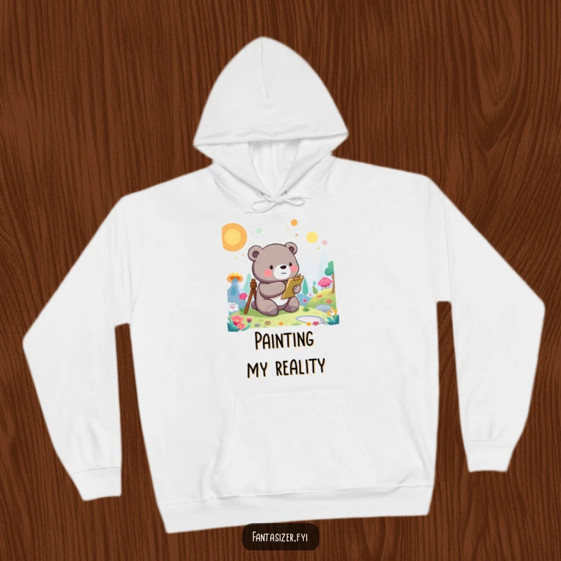 Funny Bear Hoodie: A whimsical bear character paints a vibrant, otherworldly landscape, offering cozy artistic vibes.