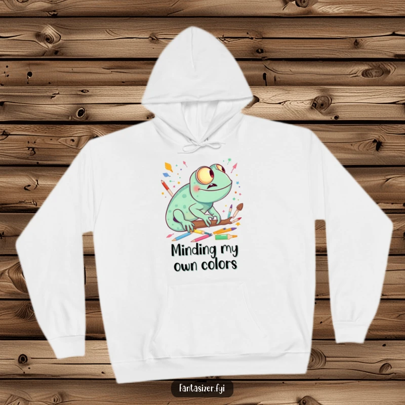 Funny chameleon wearing a hoodie, giggling while imagining a vibrant world made entirely of art supplies, soft and warm.
